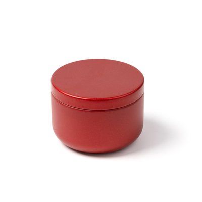 Vela aromática floral en recipiente metálico
